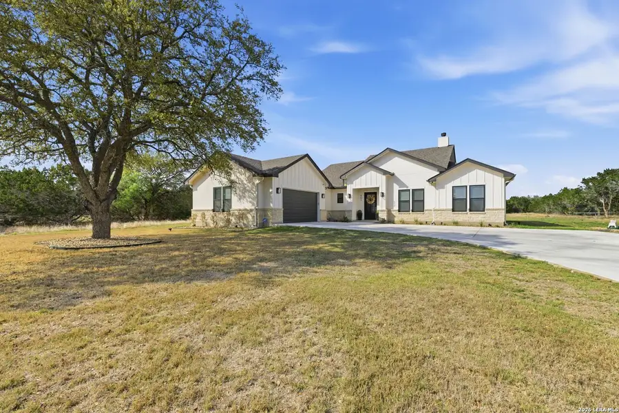 Front exterior of a new home in , Bandera, TX, highlighting curb appeal (Image 25).