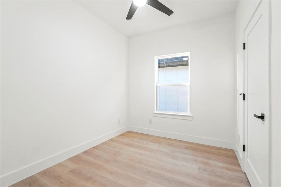 Empty room with light wood-type flooring and ceiling fan Empty room with light wood-type flooring and ceiling fan