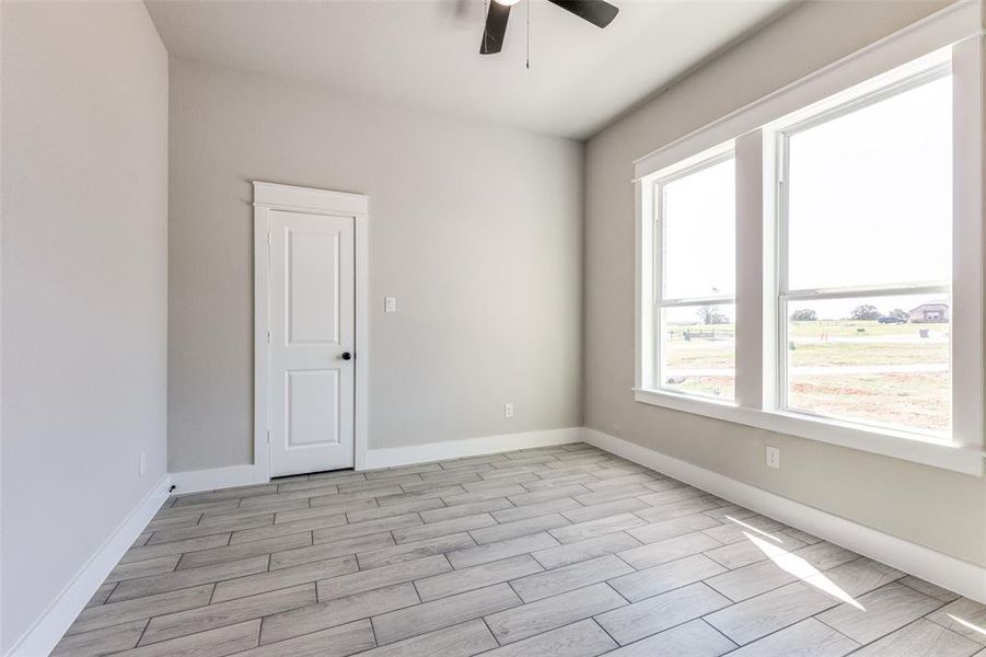 Spare room featuring ceiling fan and light hardwood / wood-style flooring