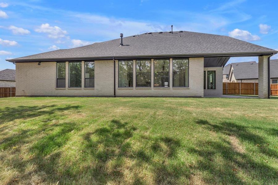 Back of house featuring a lawn