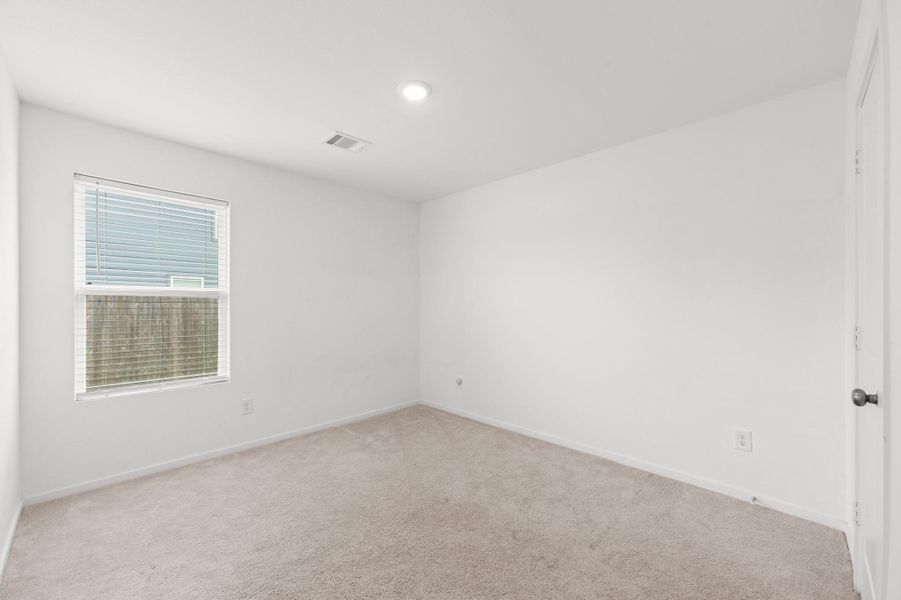 Alternate view highlights the bedroom’s versatile layout, neutral carpeting, and ample wall space for furniture placement. Alternate view highlights the bedroom’s versatile layout, neutral carpeting, and ample wall space for furniture placement.