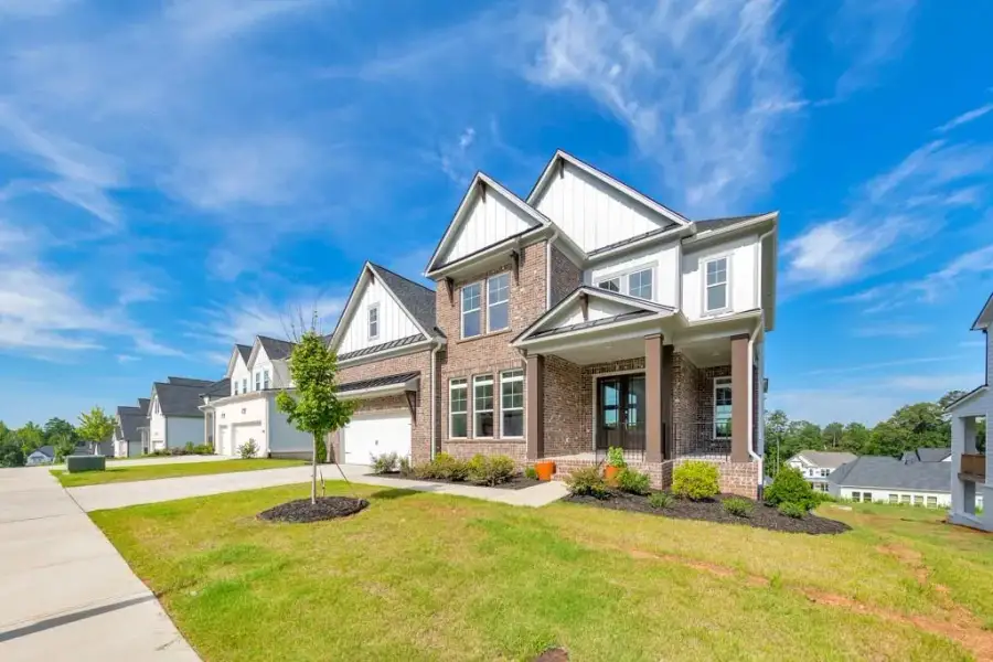Front exterior of a new home in , Woodstock, GA, highlighting curb appeal (Image 30).