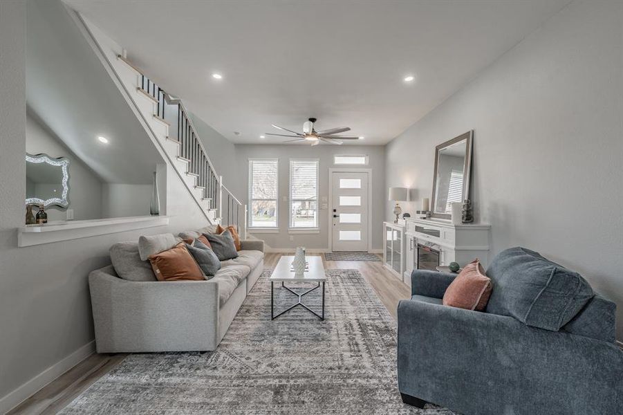 Living room featuring ceiling fan and light hardwood / wood-style flooring