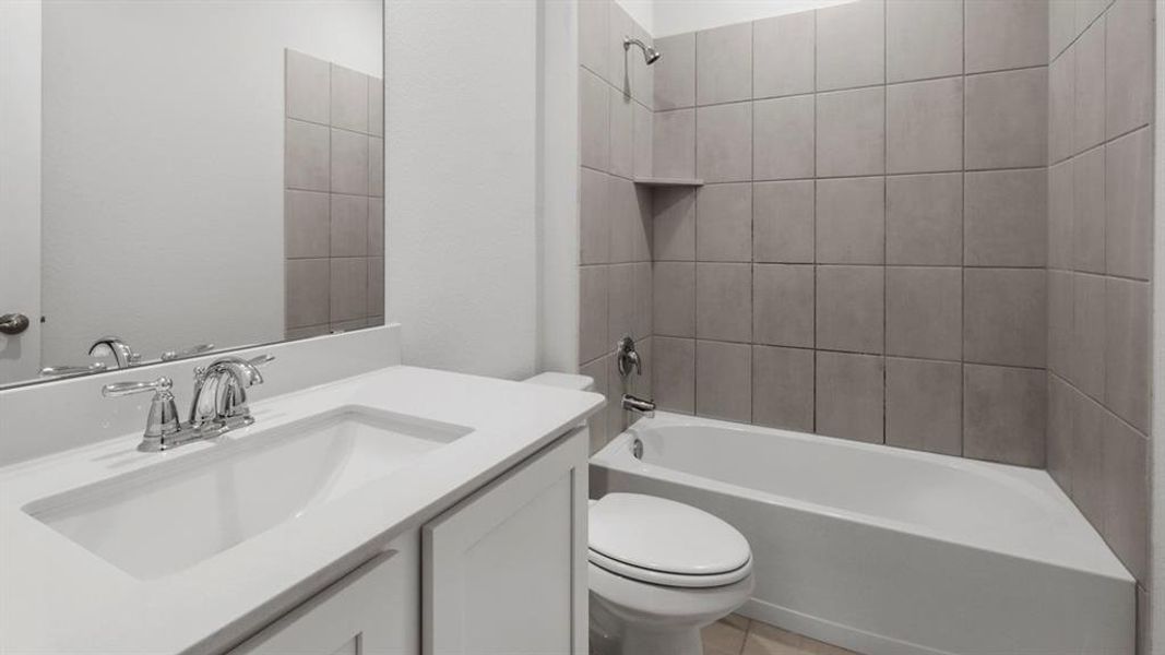 Bathroom featuring a white vanity with an integrated sink, chrome faucet, and a large mirror