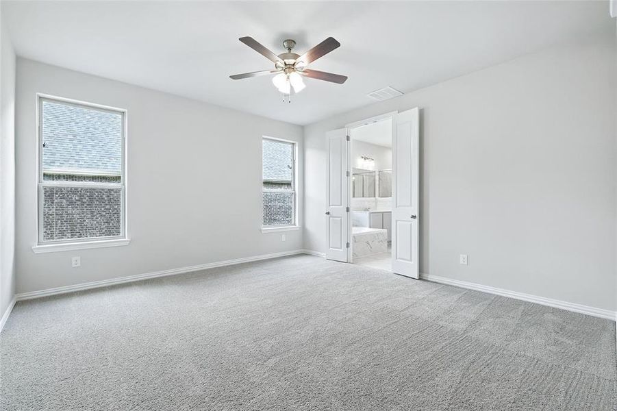 Unfurnished bedroom featuring carpet floors, a ceiling fan, and ensuite bathroom Unfurnished bedroom featuring carpet floors, a ceiling fan, and ensuite bathroom