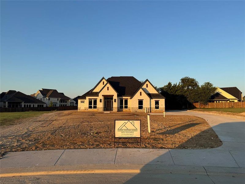 Modern inspired farmhouse featuring concrete driveway and stone siding Modern inspired farmhouse featuring concrete driveway and stone siding