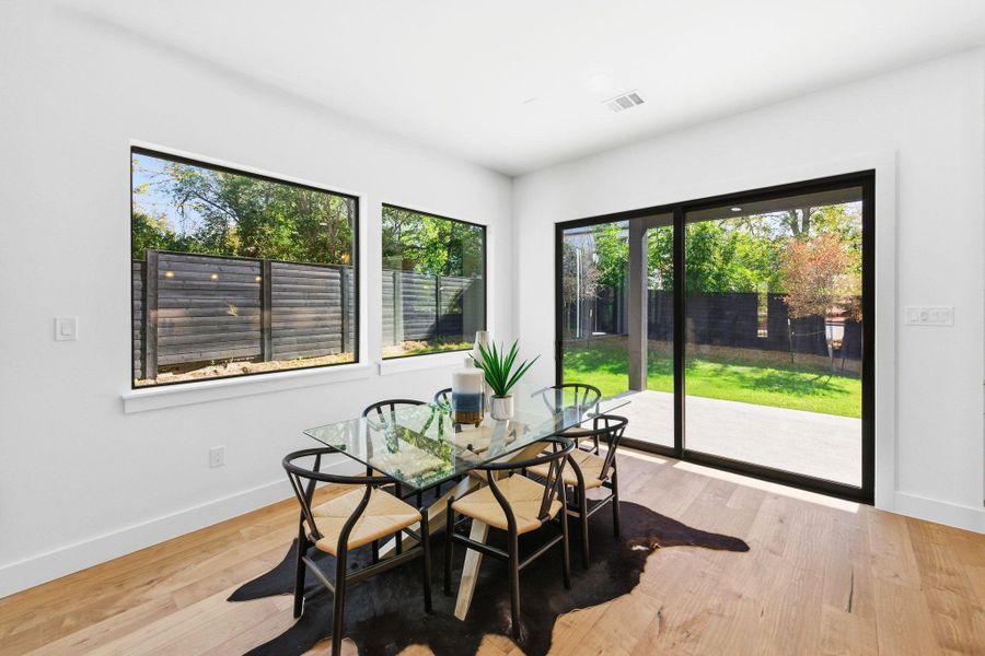 Dining area featuring light wood-style flooring and plenty of natural light Dining area featuring light wood-style flooring and plenty of natural light
