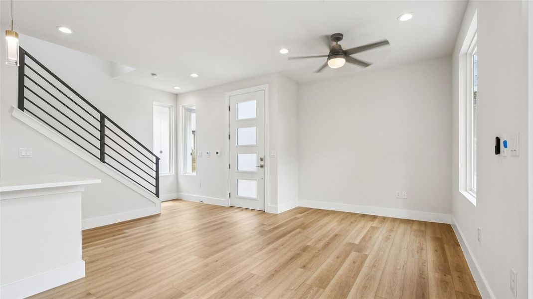 Entrance foyer with recessed lighting, healthy amount of natural light, stairs, light wood-type flooring, and ceiling fan Entrance foyer with recessed lighting, healthy amount of natural light, stairs, light wood-type flooring, and ceiling fan