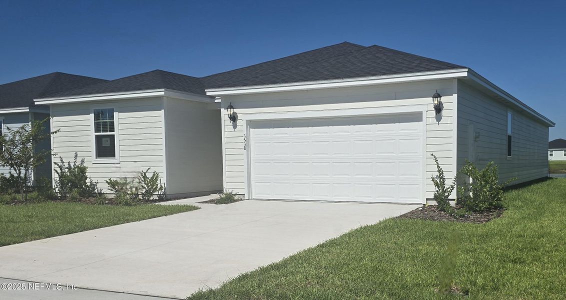 Front exterior of a new home in Lakes at Bella Lago - Signature Series, Green Cove Springs, FL, highlighting curb appeal (Image 2).