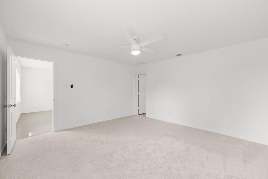 Additional view of the primary bedroom showcases its generous proportions and direct connection to the adjoining spaces. Additional view of the primary bedroom showcases its generous proportions and direct connection to the adjoining spaces.