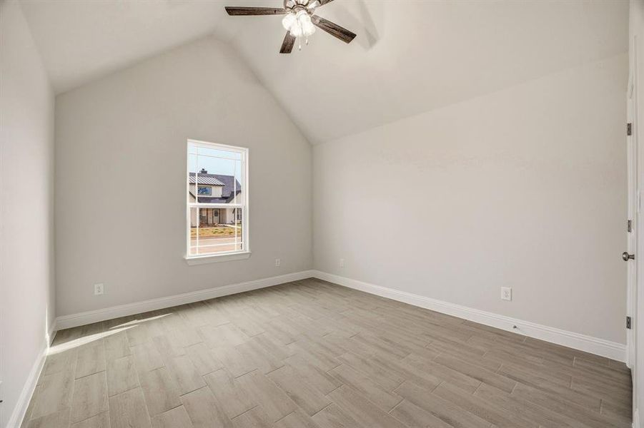 Bedroom room with tile wood finish floors and a ceiling fan