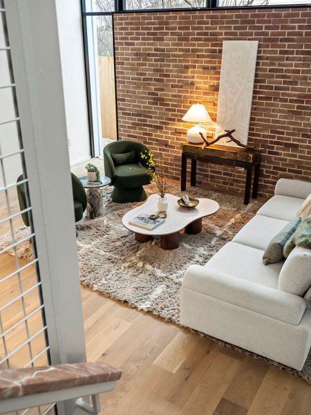 Living room with brick wall and wood finished floors Living room with brick wall and wood finished floors