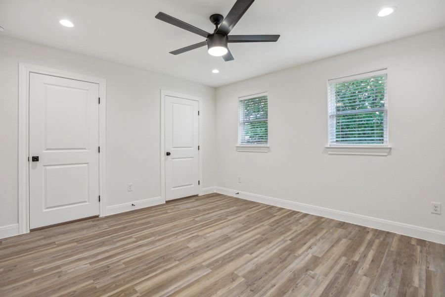 Primary  bedroom featuring recessed lighting, light wood-type flooring, baseboards, and ceiling fan