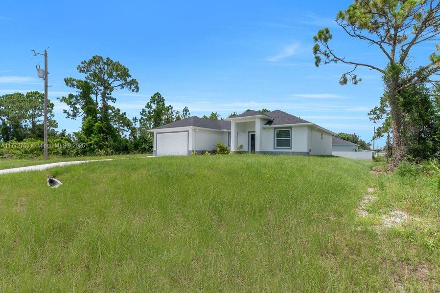 Front exterior of a new home in , Lehigh Acres, FL, highlighting curb appeal (Image 22).