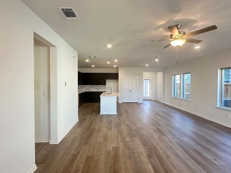 Unfurnished living room with recessed lighting, dark wood-style floors, and a ceiling fan Unfurnished living room with recessed lighting, dark wood-style floors, and a ceiling fan