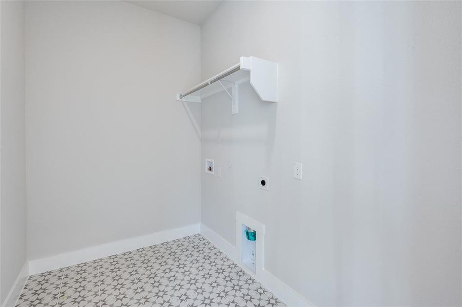 Laundry area featuring hookup for an electric dryer, tile patterned flooring, and hookup for a washing machine