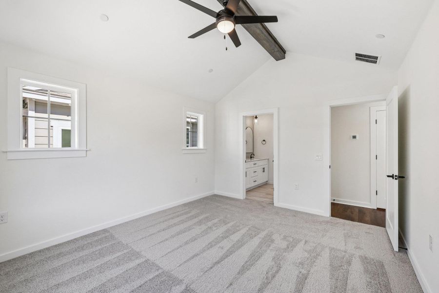 Unfurnished bedroom featuring light colored carpet, connected bathroom, and ceiling fan Unfurnished bedroom featuring light colored carpet, connected bathroom, and ceiling fan
