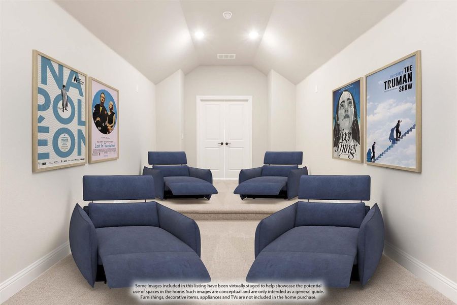 Home theater room with blue recliner chairs, vaulted ceiling, and movie poster wall art on both sides