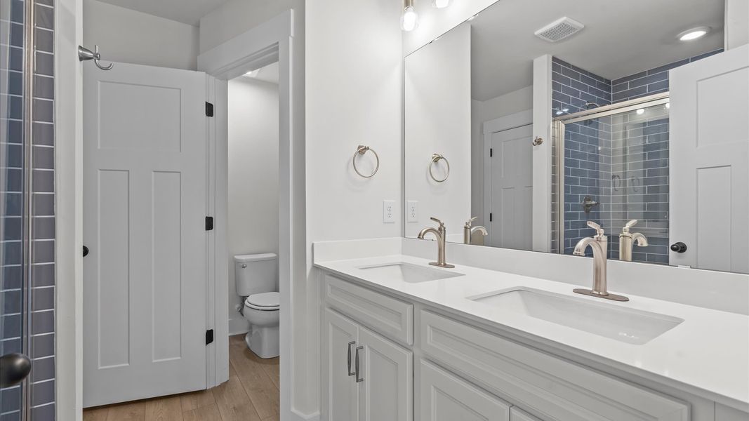 Exceptional en-suite with dual vanity and glass-enclosed walk-in shower for superior everyday comfort at Gresham Station