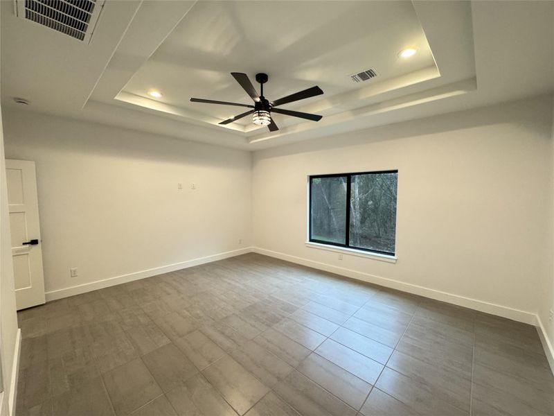 Unfurnished room featuring a tray ceiling, ceiling fan, and recessed lighting Unfurnished room featuring a tray ceiling, ceiling fan, and recessed lighting