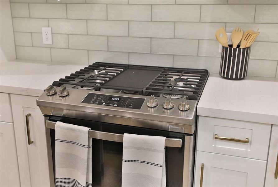 Experience culinary excellence with a sleek gas cooktop and elegant hood, ready for use in your future kitchen.