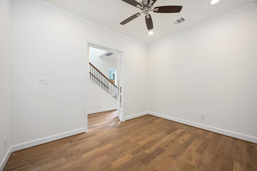 Need a quiet space to work or create? This glass-doored room near the entry is ideal for a study, Zoom room, or library—with just enough privacy to stay focused.