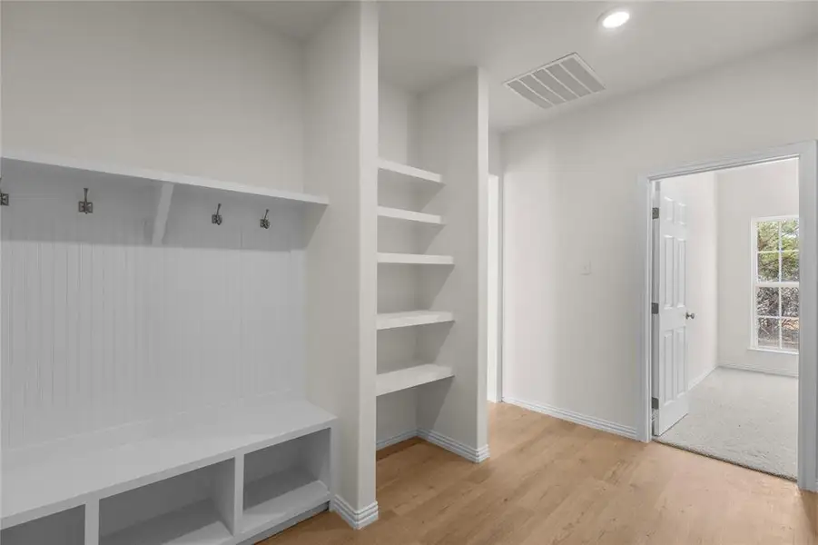 Mudroom with light wood-style floors and recessed lighting
