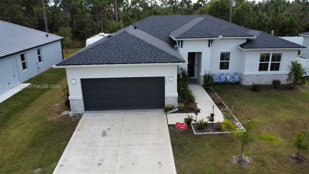 Front exterior of a new home in , Palm Bay, FL, highlighting curb appeal (Image 28).
