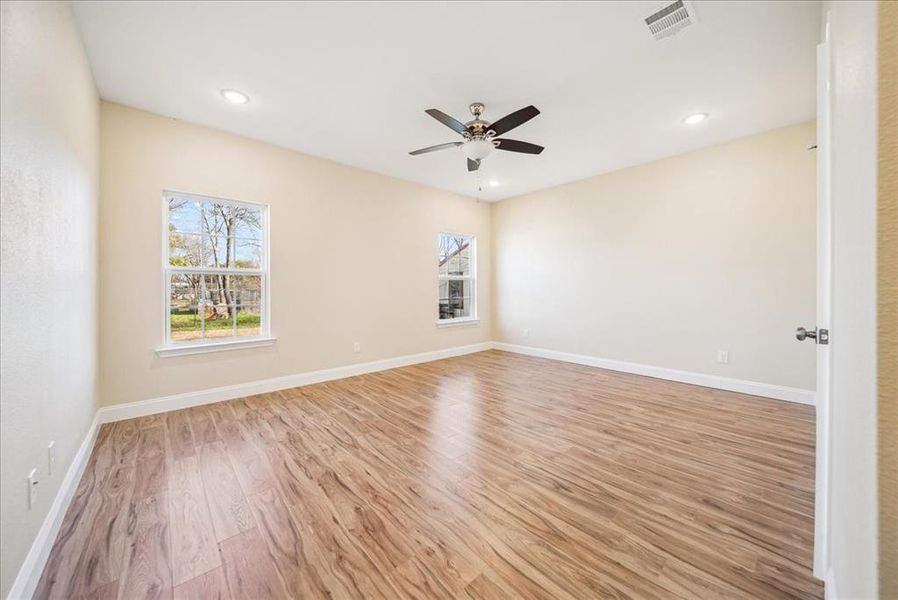 Empty room featuring light hardwood / wood-style floors and ceiling fan