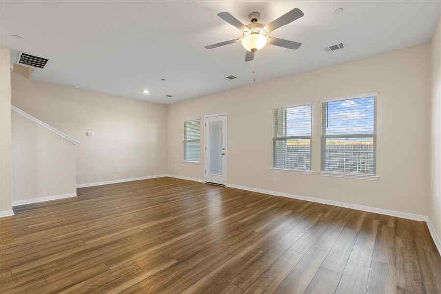 Living room with light wood-type flooring, recessed lighting, and ceiling fan Living room with light wood-type flooring, recessed lighting, and ceiling fan