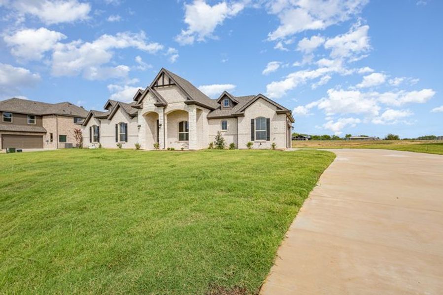 Representative exterior photo of a completed home built from the The Elm by Sumeer Homes in Stone Henge II, Sanger, TX (Image 17). Representative exterior photo of a completed home built from the The Elm by Sumeer Homes in Stone Henge II, Sanger, TX (Image 17).