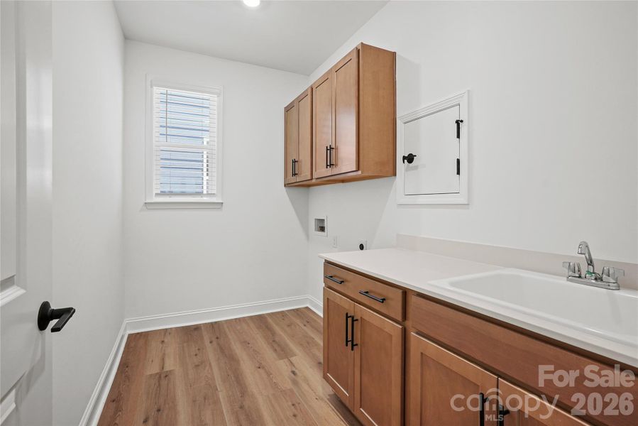 Laundry with sink and cabinets