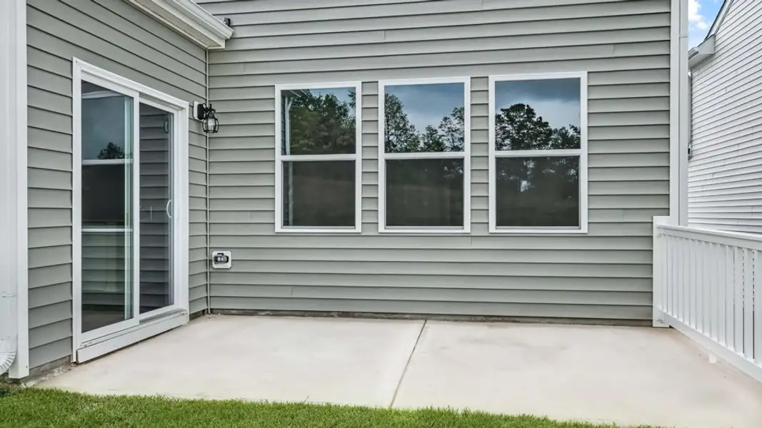 Exterior details and patio area of a home in The Grove at Matthews Landing, Fuquay Varina (Image 4).