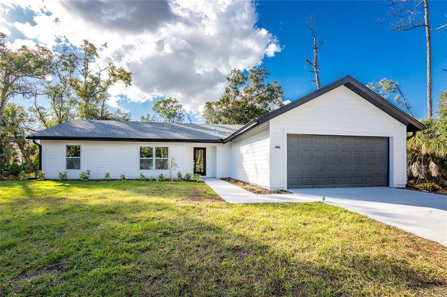 Front exterior of a new home in , North Port, FL, highlighting curb appeal (Image 21).