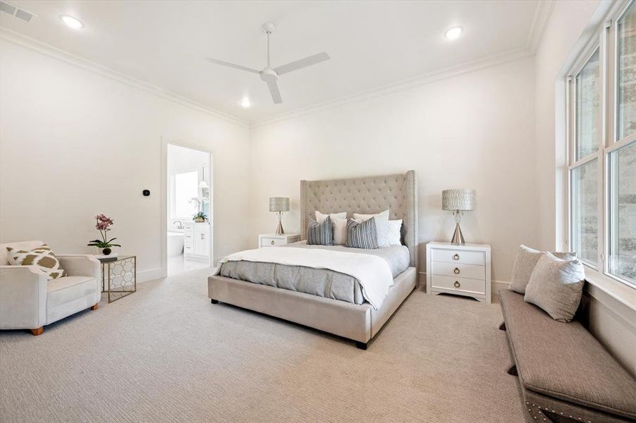 Bedroom featuring connected bathroom, carpet, multiple windows, and ceiling fan