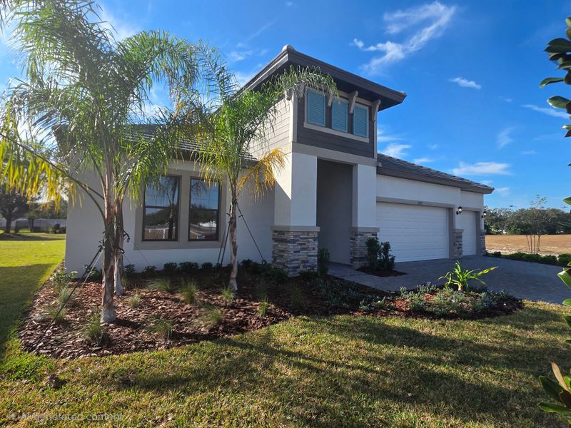 Front exterior of a new home in River Preserve Estates, Parrish, FL, highlighting curb appeal (Image 23).