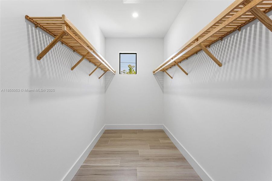Large Walk-In Closet with Upgraded Wooden Shelving Large Walk-In Closet with Upgraded Wooden Shelving