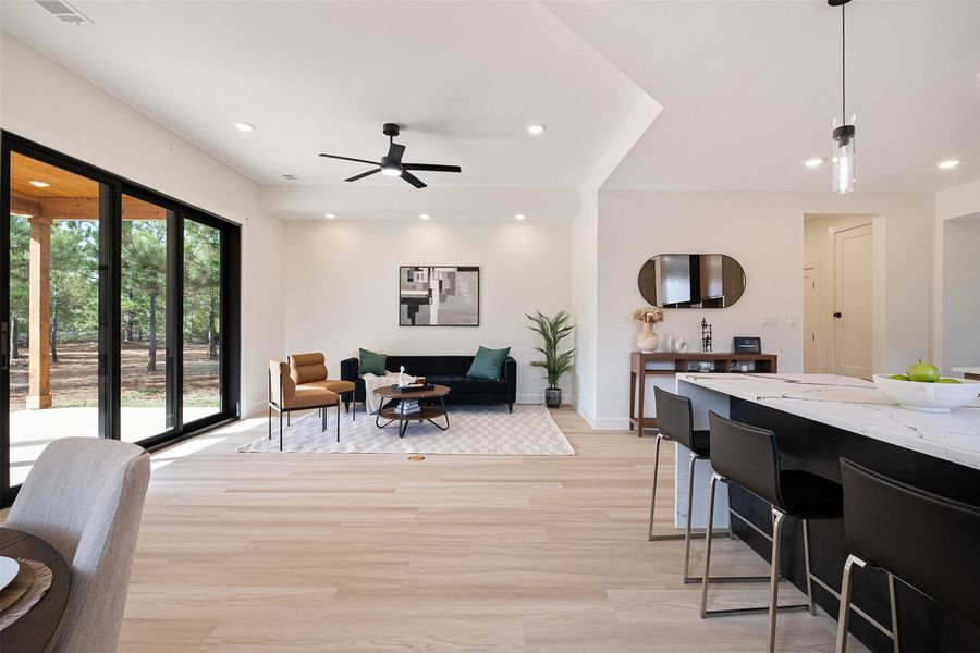 Living area with light wood-style floors, recessed lighting, and ceiling fan