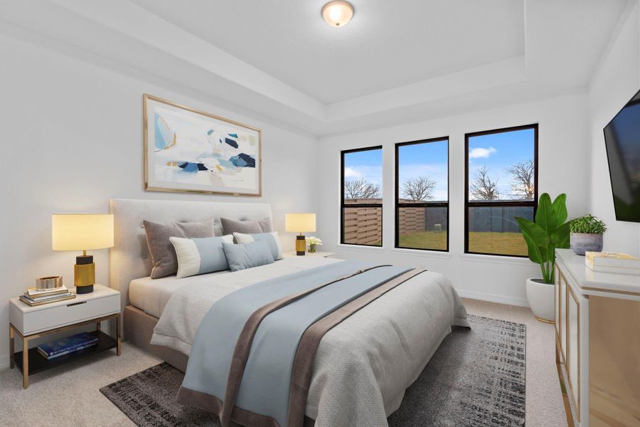 The primary bedroom is a tranquil retreat, offering timeless elegance and restful comfort.