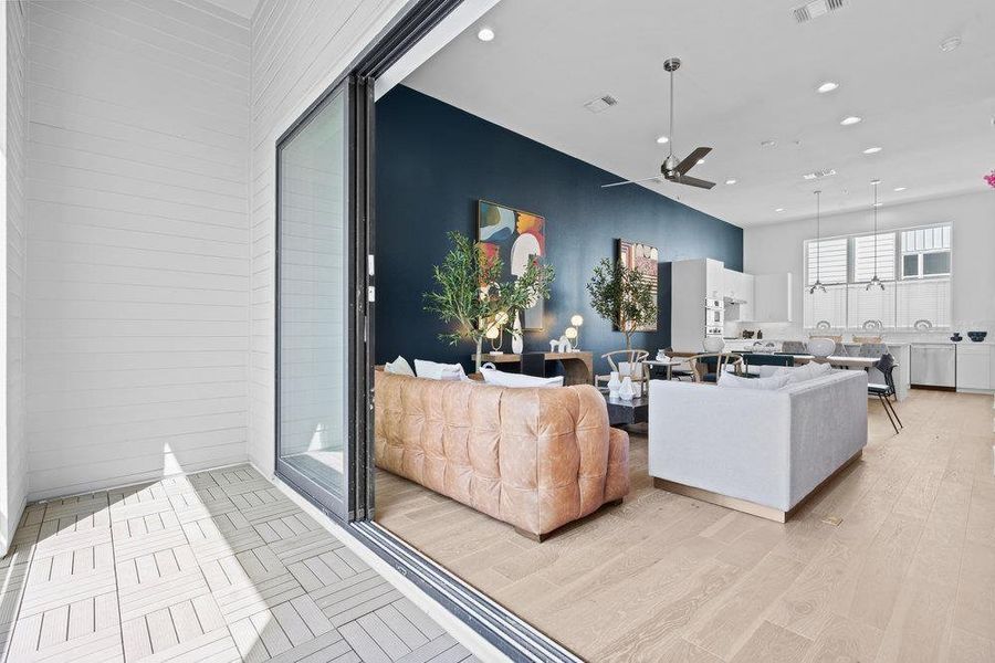 Living area with ceiling fan, recessed lighting, and light wood-style flooring
