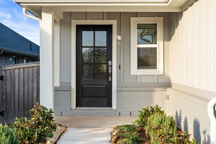 This home is modern elegance with a timeless siding and brick combination exterior and a high quality entry door.