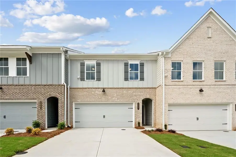 Front exterior of a new home in Wildwood Place, Powder Springs, GA, highlighting curb appeal (Image 1). Front exterior of a new home in Wildwood Place, Powder Springs, GA, highlighting curb appeal (Image 1).