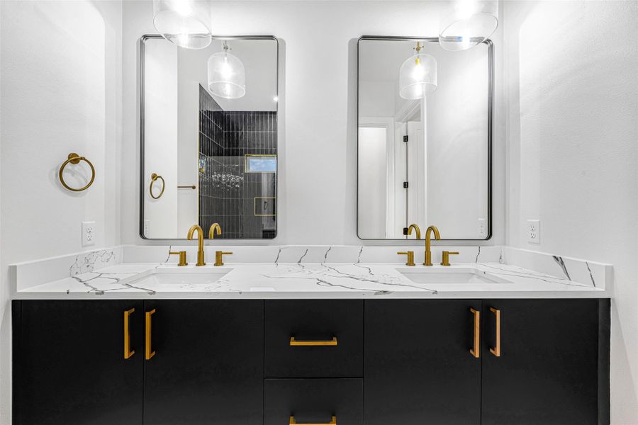 Full bath featuring a double vanity and a tile shower. Full bath featuring a double vanity and a tile shower.
