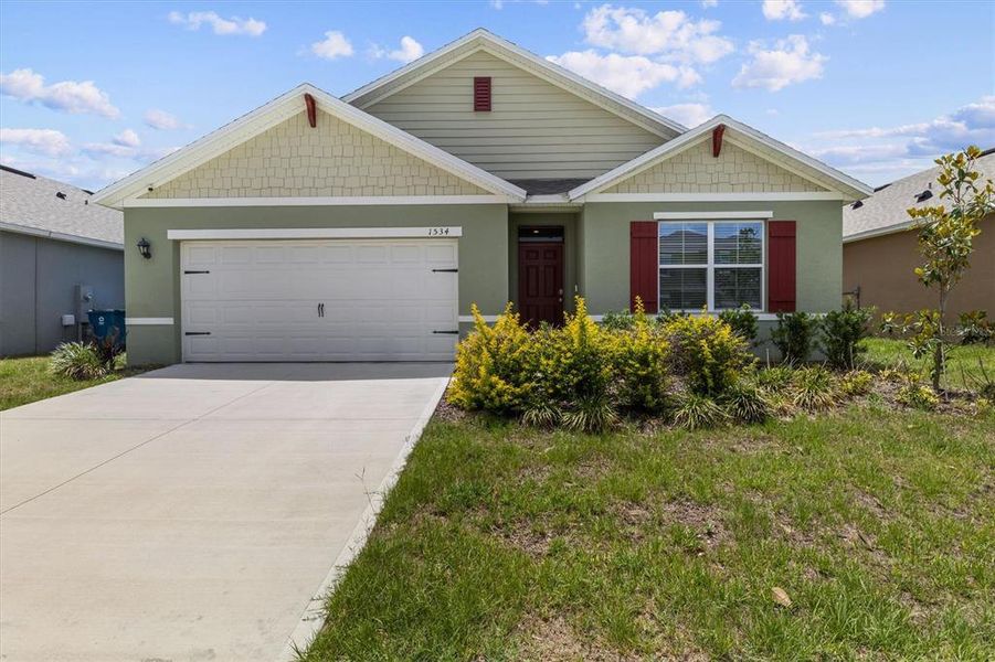 Front exterior of a new home in Cypress Park Estates, Haines City, FL, highlighting curb appeal (Image 25).