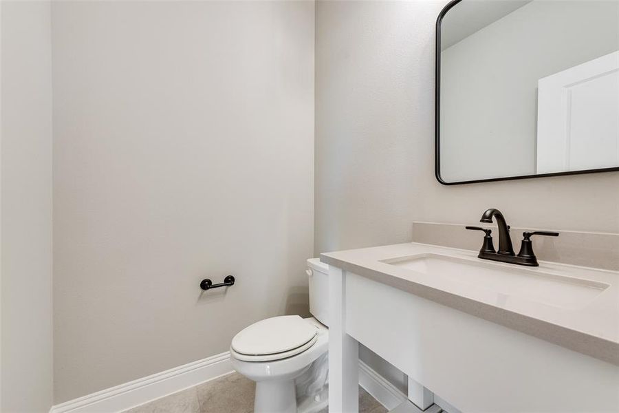 Bathroom with tile patterned flooring, vanity, and toilet