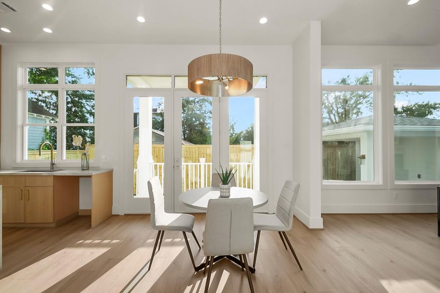 Surrounded by natural light, the breakfast area offers the perfect casual dining space with views overlooking the backyard and outdoor patio.
