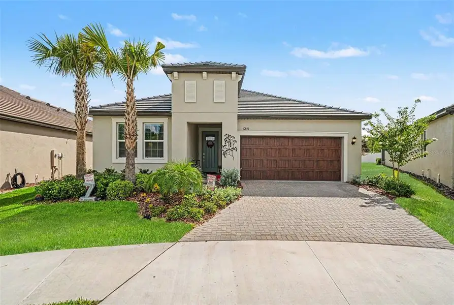 Front exterior of a new home in Angeline Active Adult, Land O' Lakes, FL, highlighting curb appeal (Image 1). Front exterior of a new home in Angeline Active Adult, Land O' Lakes, FL, highlighting curb appeal (Image 1).