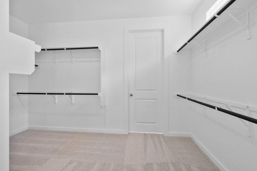 Walk-in closet in Primary Bedroom Walk-in closet in Primary Bedroom