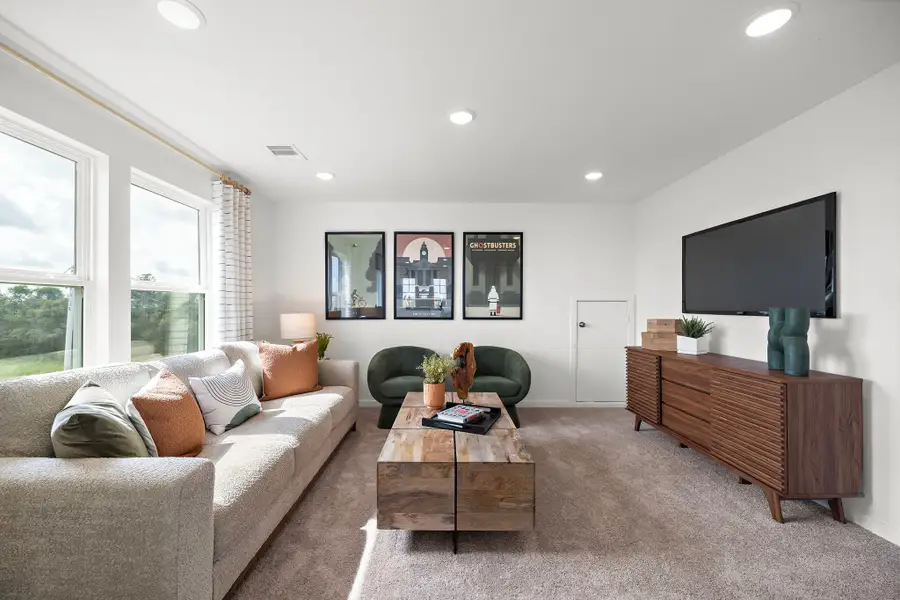 A living room with a tv and couches.