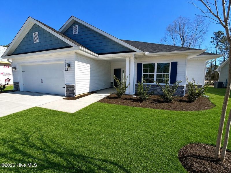 Front exterior of a new home in Wood Creek Landing, Leland, NC, highlighting curb appeal (Image 2). Front exterior of a new home in Wood Creek Landing, Leland, NC, highlighting curb appeal (Image 2).